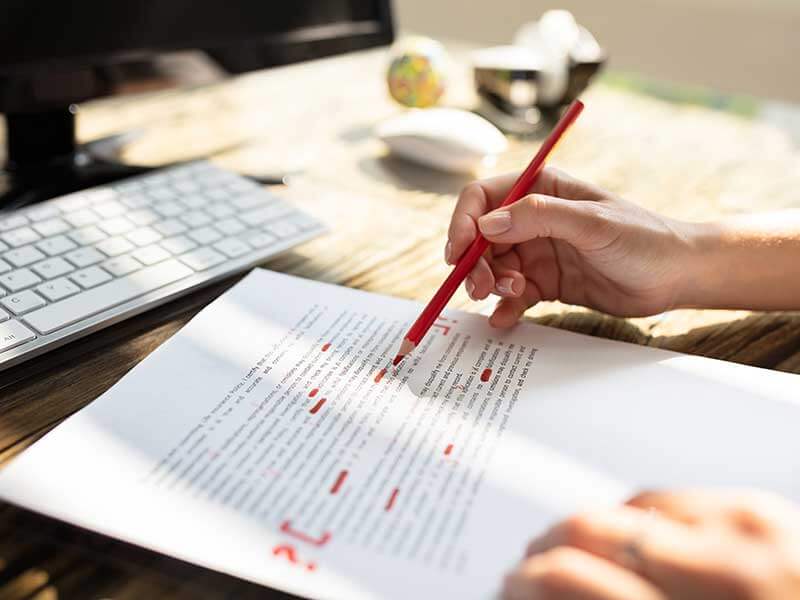 Person's Hand Editing Document
